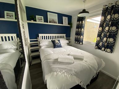 A bedroom with a bed and window at Chalet 333 California, Norfolk