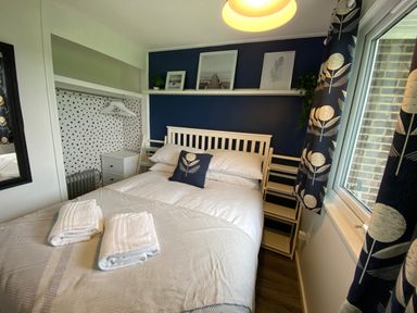 A bedroom with a bed and shelves at Chalet 333 in California, Norfolk
