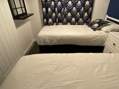 A bedroom with two beds and a shelf at Chalet 333 in California, Norfolk