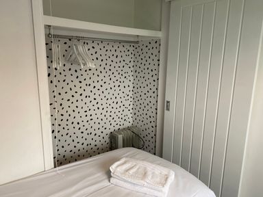 A bedroom with a hanging rail and towels at Chalet 333, California, Norfolk