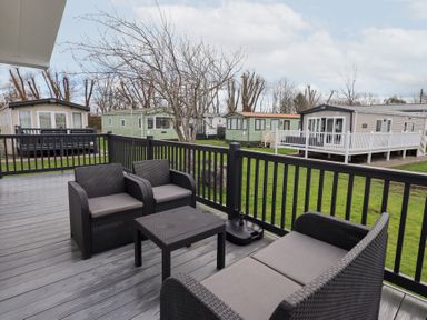 An outdoor seating area with chairs and table at Lily's Lodge in Morecambe