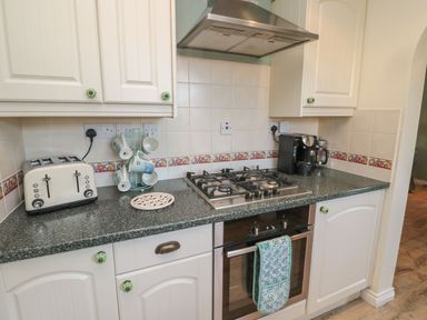 A kitchen with appliances and utensils at Sandy Cove in Chathill