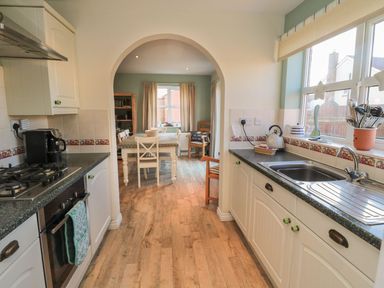 A kitchen with a sink and stove at Sandy Cove, Chathill