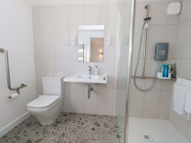 A bathroom with a shower, toilet, and sink at The Pebble in Dorchester
