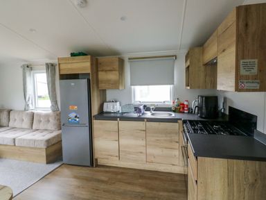 A kitchen with a fridge, stove, and sink at Valley 36 in Kingsbridge