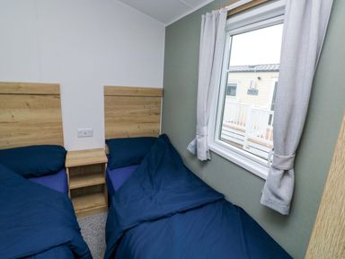 A bedroom with two beds and a window at Valley 36 in Kingsbridge