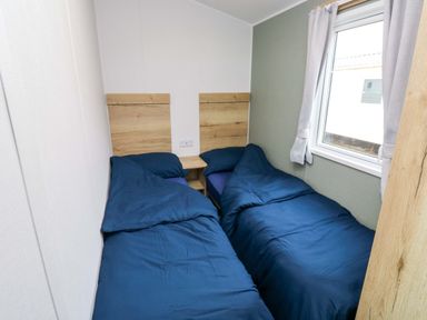 A bedroom with two beds and a window at Valley 36 in Kingsbridge
