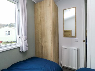 A bedroom with a bed and wardrobe at Valley 36 in Kingsbridge