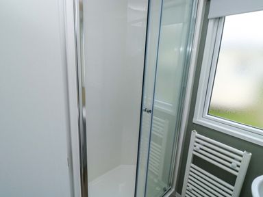A bathroom with a shower and towel radiator at Valley 36 in Kingsbridge