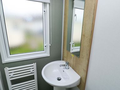 A bathroom with a sink and mirror at Valley 36 in Kingsbridge