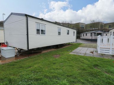 A trailer on grass with patio stones at Valley 36 in Kingsbridge
