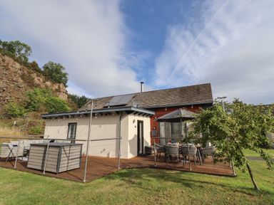 A house with decking and furniture at Summerset Lodge in Bamburgh