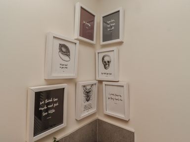 A collection of framed art on a wall at Summerset Lodge in Bamburgh