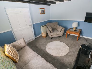 A living room with a sofa and armchair at Beacon House Marloes near Little Haven
