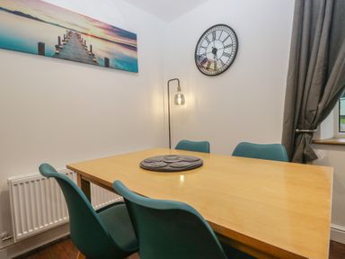 A dining room with a table and chairs at 6 Hallin Fell in Penrith