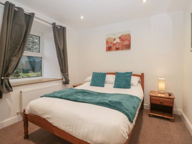 A bedroom with a bed and nightstand at 6 Hallin Fell in Penrith