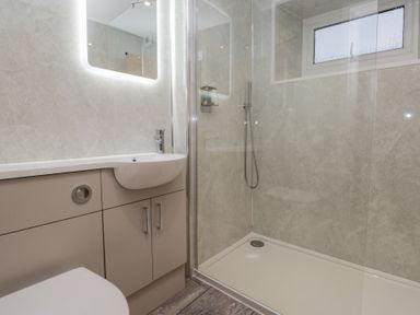 A bathroom featuring a shower, sink, and toilet at 6 Hallin Fell in Penrith
