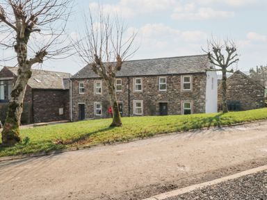 A house with trees and grass in front at 6 Hallin Fell in Penrith