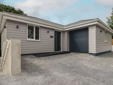 A house with a garage and entrance at Creek Lodge in Chacewater