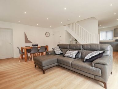 A living room with a sofa and dining table at Creek Lodge in Chacewater