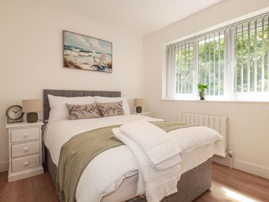 A bedroom with a bed and bedside table at Creek Lodge in Chacewater