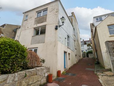 A building with windows and a door along a pathway at Flat 3