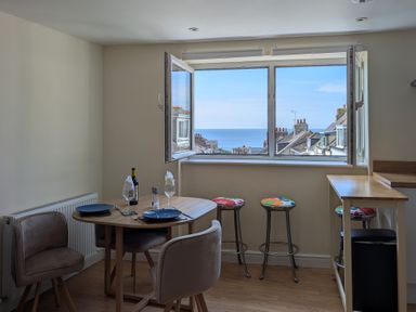 A dining room with a table and chairs at Flat 3 Fortuneswell