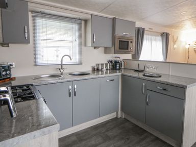 A kitchen with a stove and sink at The Ridgeway in New Quay