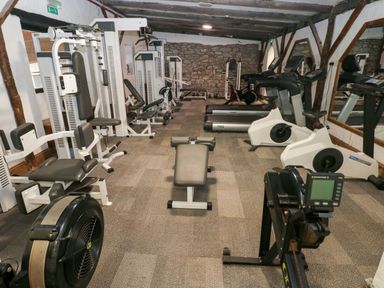 A gym with various exercise machines at The Pod in Ferryside