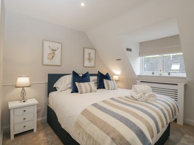 A bedroom with a bed and bedside table at Paddock View in Stow-On-The-Wold