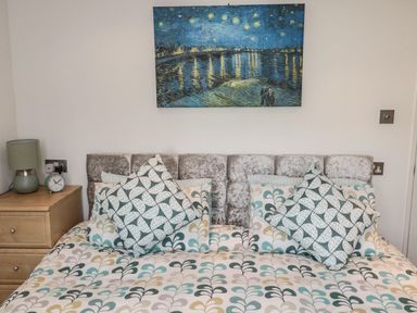 A bedroom with a bed and bedside table at Nevaeh Lodge in Longframlington