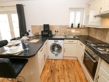 A kitchen with a washing machine and countertop space at Red Kite Cottage Haverfordwest
