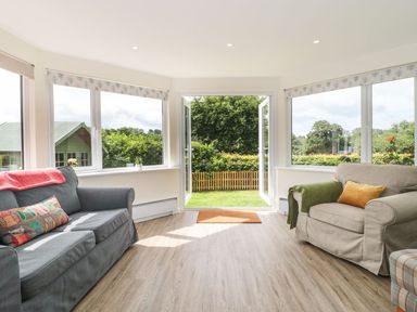 A sitting room with sofas and large windows at Ammerham Farm Cottage Ammerham near Winsham