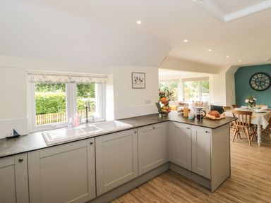 A kitchen with a sink and dining area at Ammerham Farm Cottage in Ammerham near Winsham