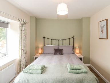 A bedroom with a bed and curtains at Ammerham Farm Cottage Ammerham near Winsham