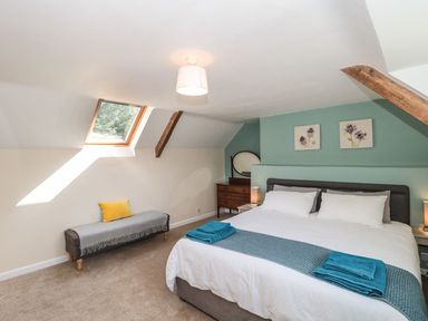 A bedroom with a bed and dresser at Ammerham Farm Cottage Ammerham near Winsham