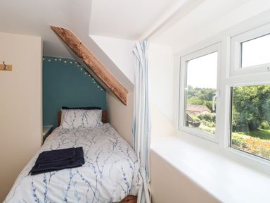 A bedroom with a bed and window at Ammerham Farm Cottage Ammerham near Winsham