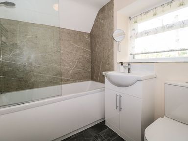 A bathroom with a bathtub and sink at Ammerham Farm Cottage Ammerham near Winsham