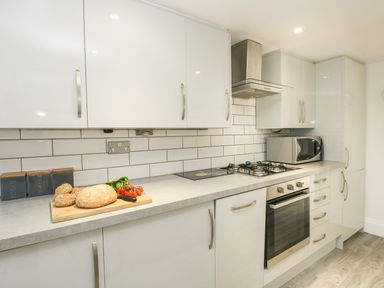 A kitchen with cabinets and appliances at Ocean Wave in Greenhill