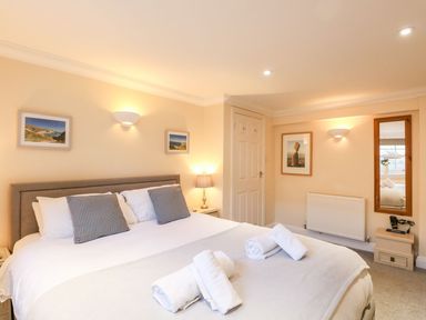 A bedroom with a bed and bedside lamp at Ocean Wave in Greenhill