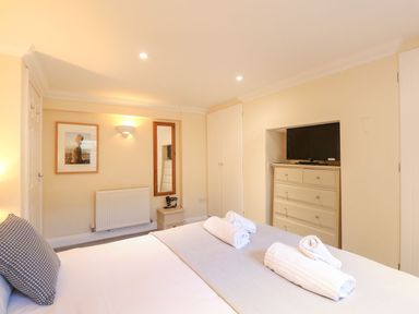 A bedroom with a bed and towels arranged at Ocean Wave in Greenhill