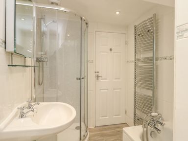 A bathroom with a shower and sink at Ocean Wave in Greenhill