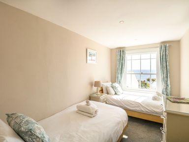 A bedroom with two beds and a window at Ocean Wave in Greenhill