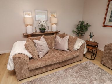 A living room with a sofa and decorative items at Tigh-Na-Mara Retreat