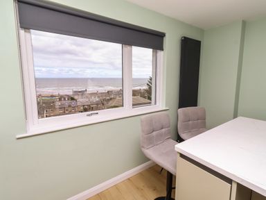 A dining room with a view of the sea at Tigh-Na-Mara Retreat 