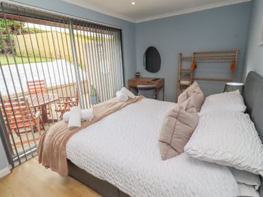 A bedroom with a bed and bedside table at Tigh-Na-Mara Retreat