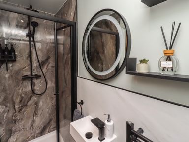 A bathroom with shower and sink at Tigh-Na-Mara Retreat