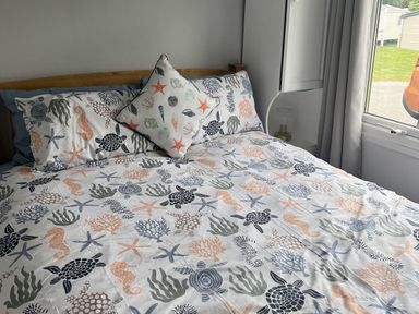 A bedroom with a bed and decorative pillows at Chalet - Buckland 16, Bideford