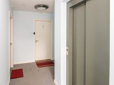 A hallway with an elevator and door at Mill Wharf in Berwick-upon-Tweed