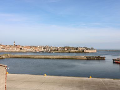 A view of water and buildings from a pier at Mill Wharf in Berwick-upon-Tweed